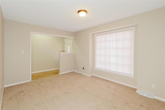 empty room featuring light colored carpet