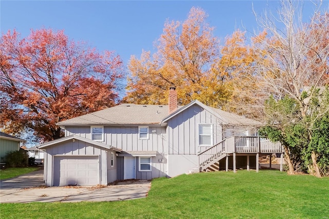 rear view of house with a yard and a wooden deck