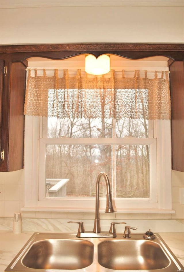 interior details featuring backsplash and sink