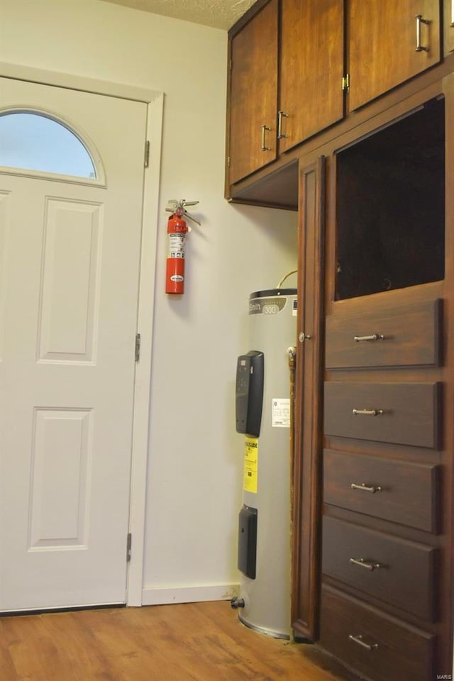 utility room with electric water heater