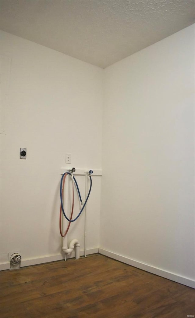 washroom featuring electric dryer hookup, dark hardwood / wood-style floors, and hookup for a washing machine