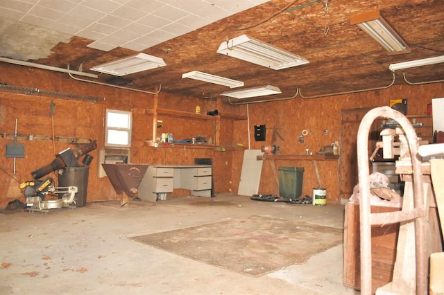 garage featuring wood walls