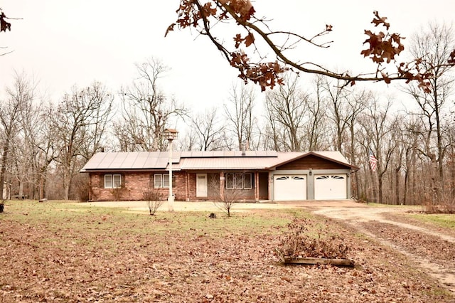 ranch-style home with a front yard and a garage