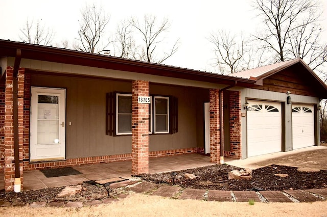 single story home with covered porch and a garage