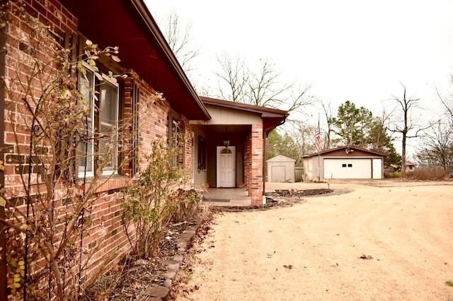 view of home's exterior with a garage and an outdoor structure