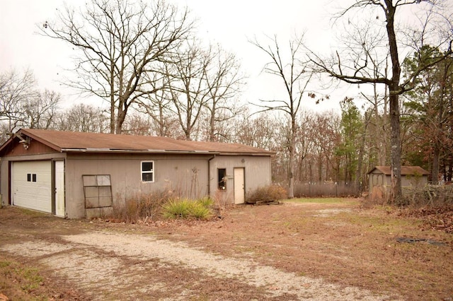 exterior space with an outbuilding and a garage