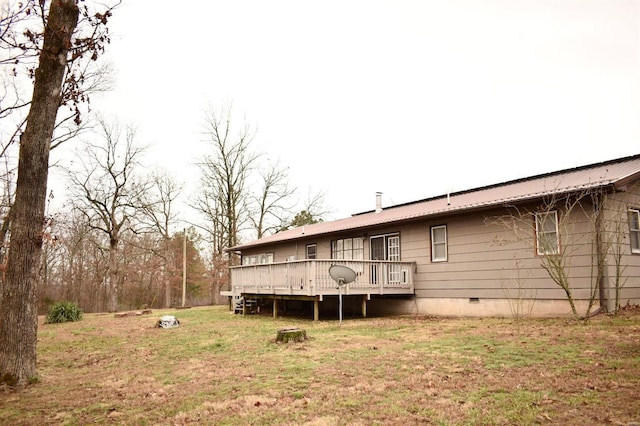 back of house featuring a yard and a wooden deck