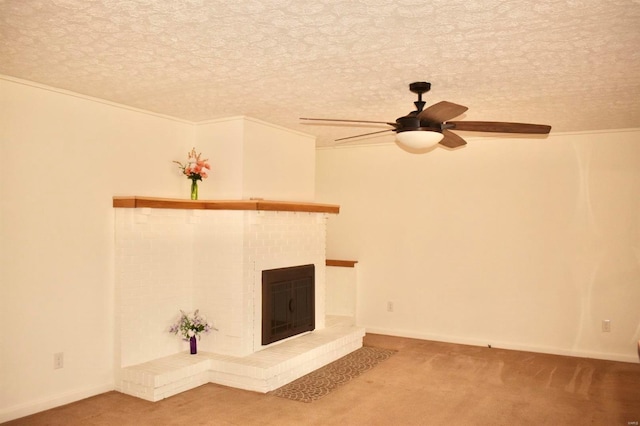 unfurnished living room with ceiling fan, carpet, ornamental molding, and a brick fireplace