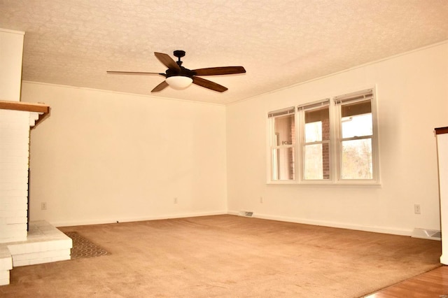 unfurnished living room with ceiling fan, ornamental molding, a textured ceiling, and a brick fireplace