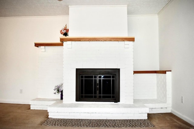 interior details featuring a fireplace, carpet, and crown molding