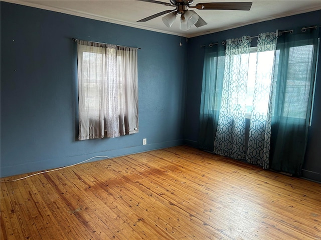 empty room featuring light hardwood / wood-style floors, ceiling fan, and crown molding