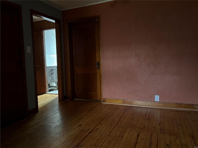 unfurnished room featuring crown molding and hardwood / wood-style flooring