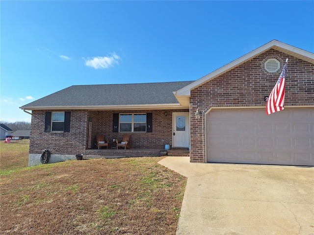 ranch-style home with covered porch, a garage, and a front lawn