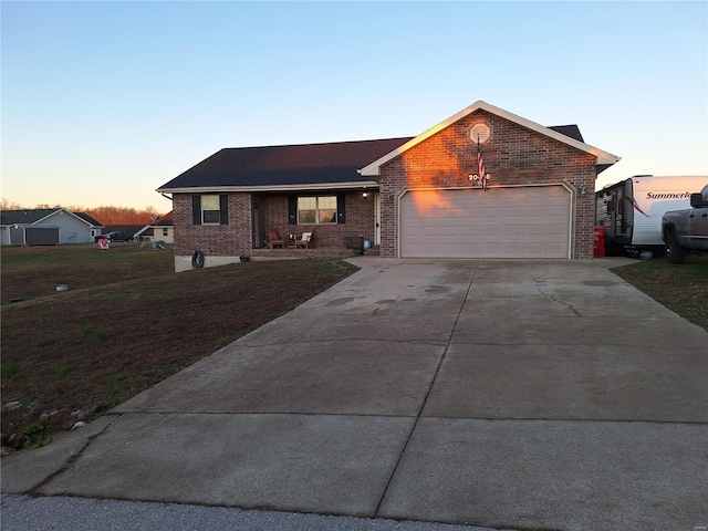 ranch-style home featuring a yard and a garage