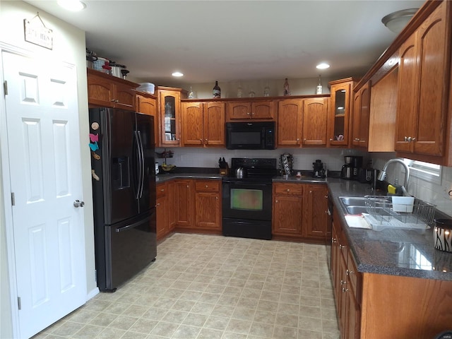 kitchen with sink, backsplash, and black appliances