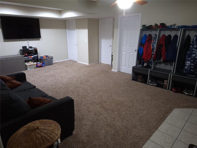 living room with ceiling fan and light tile patterned flooring