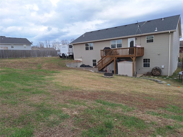 back of property with a lawn, a wooden deck, and central AC