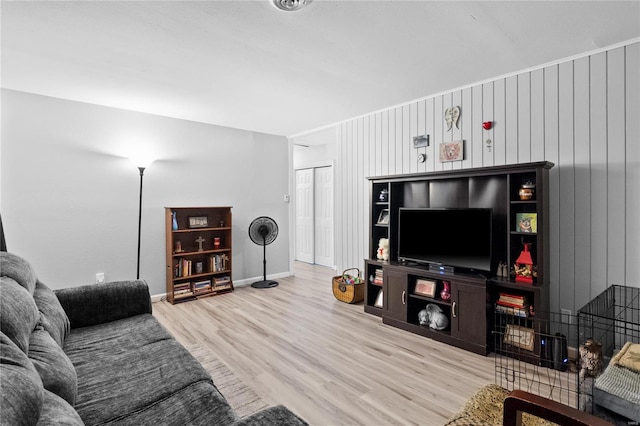 living room with hardwood / wood-style flooring and wooden walls