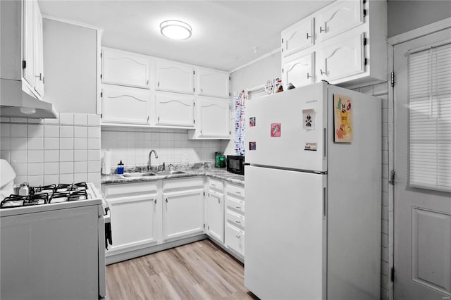 kitchen with gas stove, sink, white refrigerator, white cabinets, and light wood-type flooring