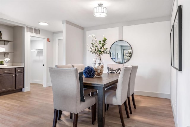 dining space with light wood-type flooring