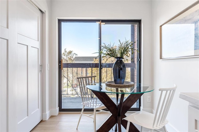 dining space with plenty of natural light and light hardwood / wood-style floors