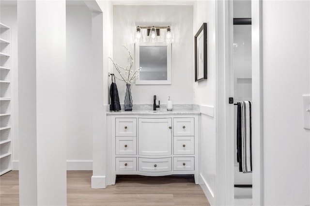 bathroom featuring hardwood / wood-style flooring and vanity