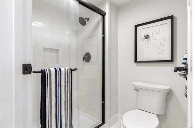 bathroom featuring toilet and walk in shower