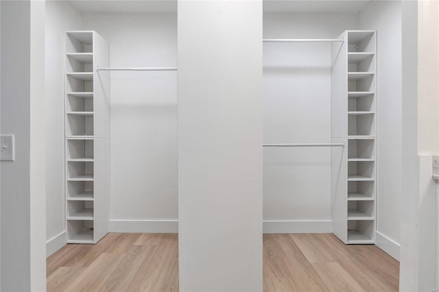 walk in closet with light wood-type flooring