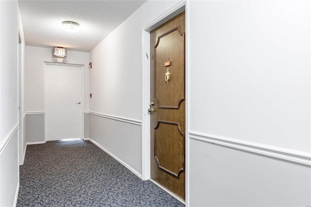 corridor featuring a textured ceiling