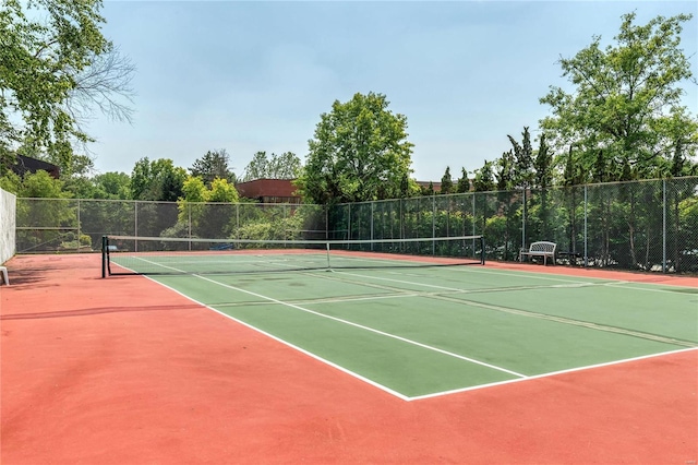 view of tennis court featuring basketball hoop