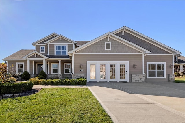 craftsman house with french doors and a front lawn