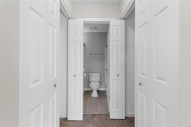 bathroom with wood-type flooring and toilet