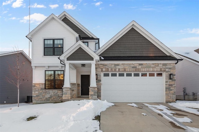 craftsman house with central AC and a garage