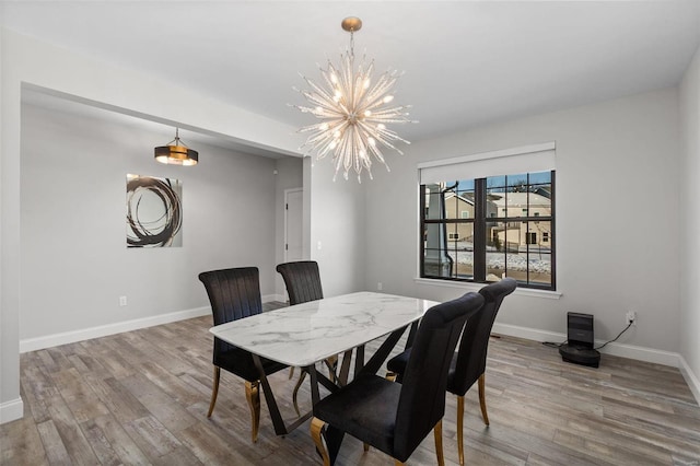 dining area with a notable chandelier and wood-type flooring