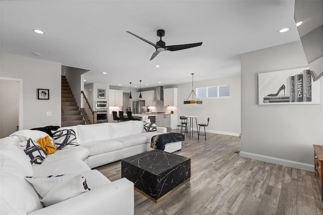 living room featuring ceiling fan and wood-type flooring