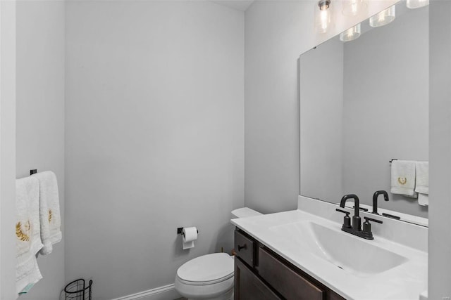 bathroom featuring toilet and vanity