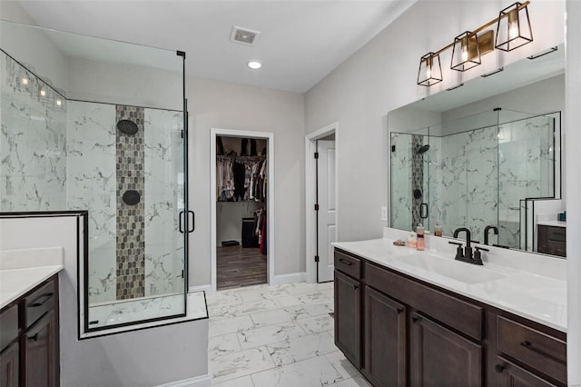 bathroom with an enclosed shower and vanity