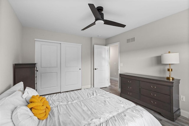 bedroom with ceiling fan, light hardwood / wood-style floors, and a closet