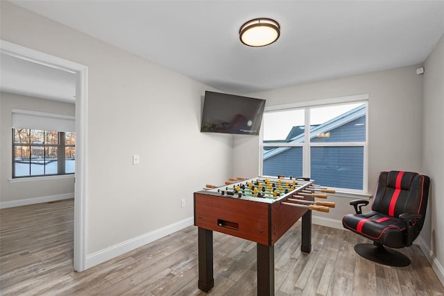 game room featuring light wood-type flooring and plenty of natural light