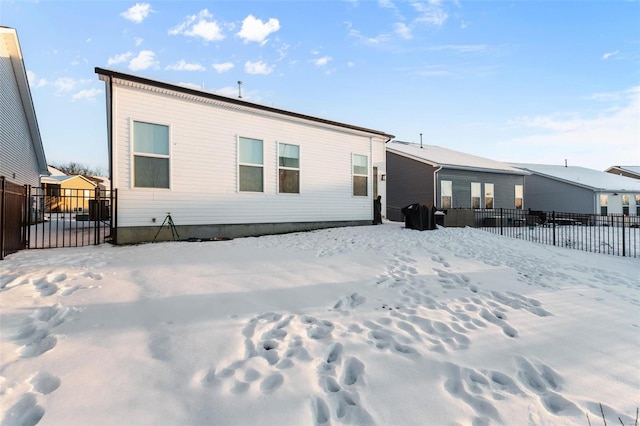 view of snow covered rear of property