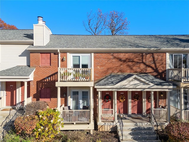 view of front of property with covered porch and a balcony