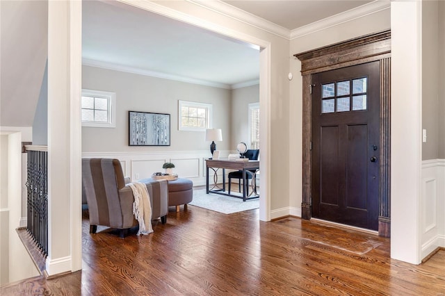 foyer with hardwood / wood-style flooring and ornamental molding