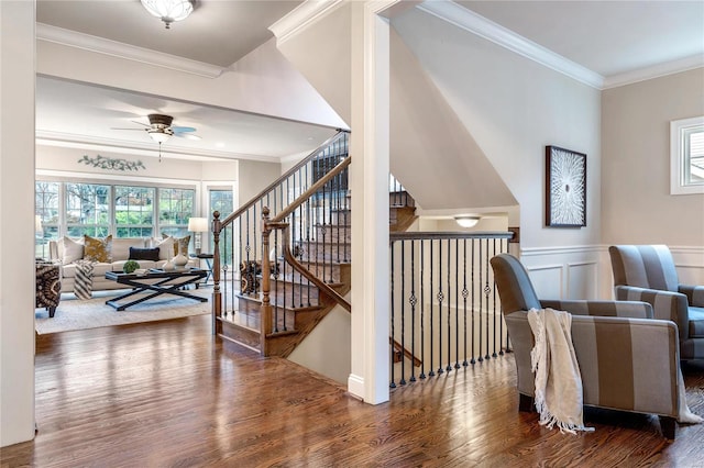 living area featuring hardwood / wood-style flooring, ceiling fan, and ornamental molding