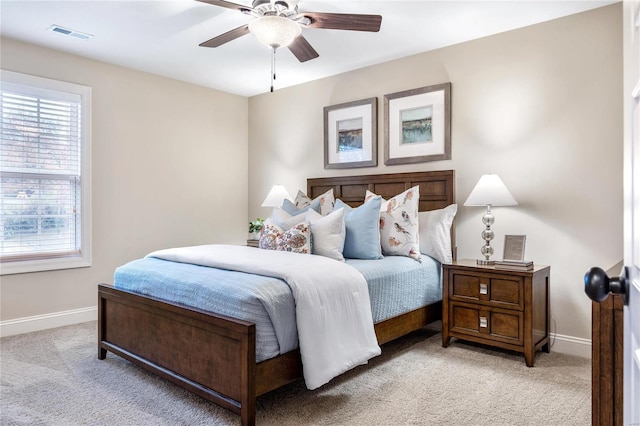 bedroom with ceiling fan and light carpet