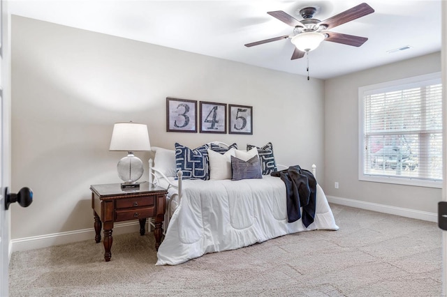 bedroom featuring light colored carpet and ceiling fan