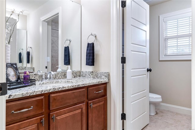 bathroom featuring tile patterned floors, vanity, and toilet