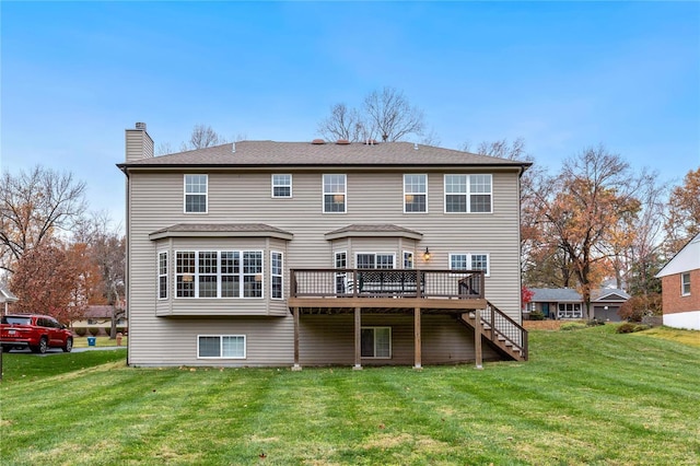 rear view of house featuring a lawn and a wooden deck