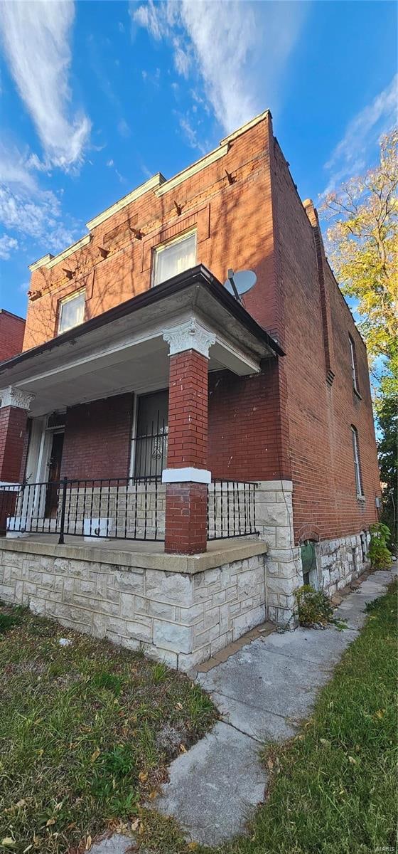 view of side of home featuring a porch