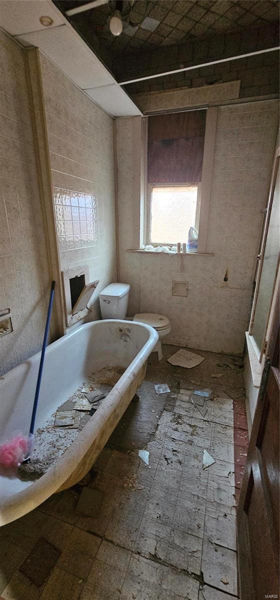 bathroom featuring a bath and toilet