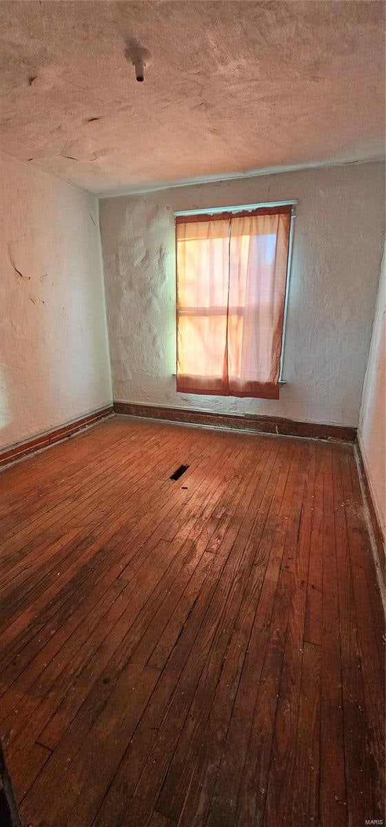 spare room with wood-type flooring